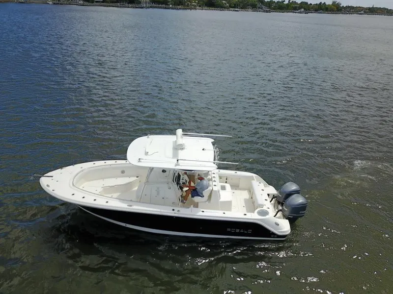 Slide: The Image of 2015 Robalo R300 Center Console boat cruising on a calm lake. - 38