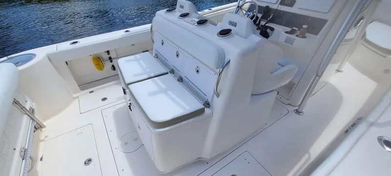 Slide: The Image of 2015 Robalo R300 Center Console boat interior with seating and storage. - 4
