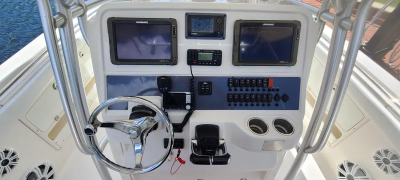Slide: The Image of 2015 Robalo R300 Center Console helm with dual Lowrance displays and controls. - 6