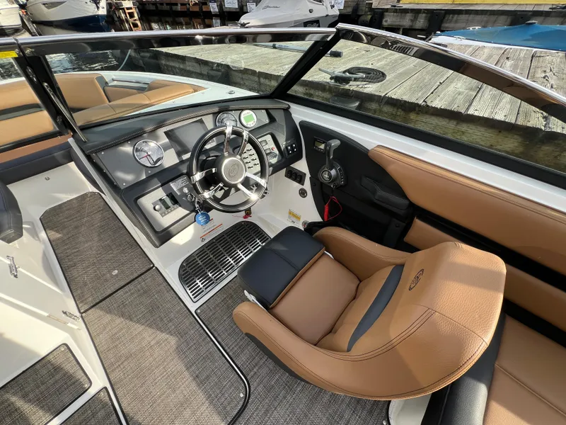 Slide: The Image of 2023 Cobalt CS23 Surf boat interior with sleek dashboard and luxurious seating. - 16