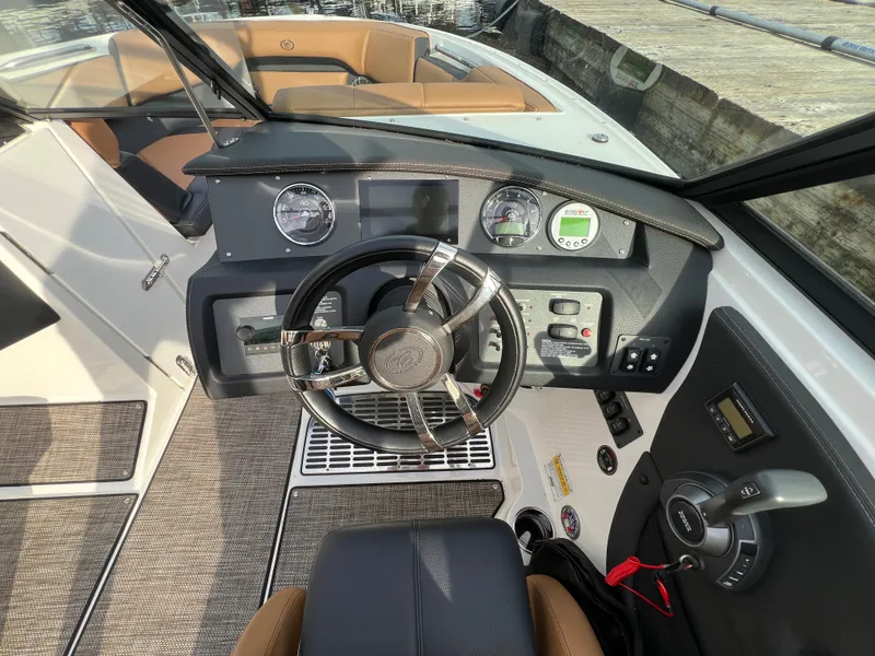 Slide: The Image of 2023 Cobalt CS23 Surf boat dashboard with steering wheel and control panel. - 17