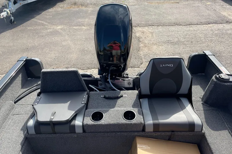 Slide: The Image of 2025 Lund 1650 Rebel XL SS boat interior with motor and seating. - 8