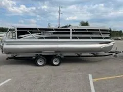 Slide: The Image of 2023 Sweetwater 2286SFL pontoon boat on a trailer in a parking lot. - 9
