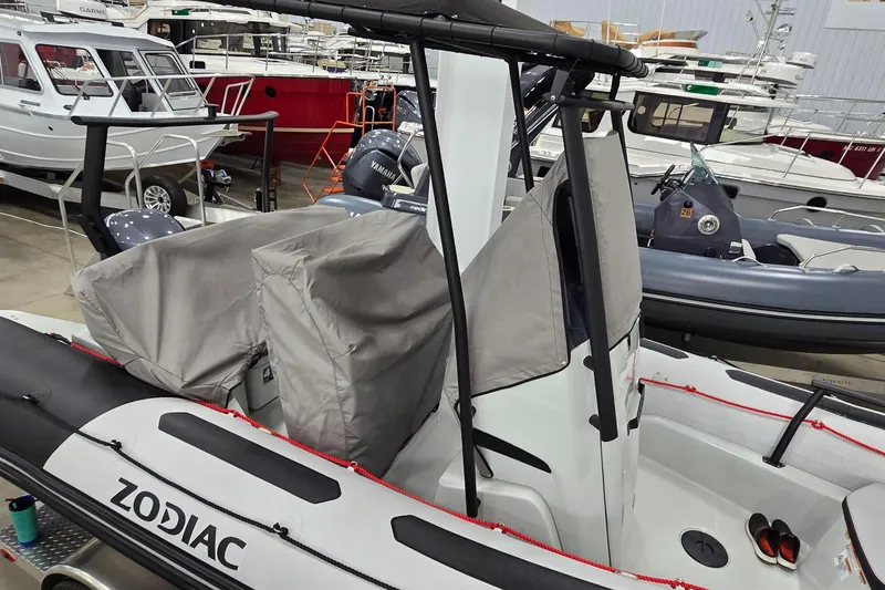 Slide: The Image of 2023 Zodiac Open 5.5 PVC boat storage compartment with red rope detail. - 19