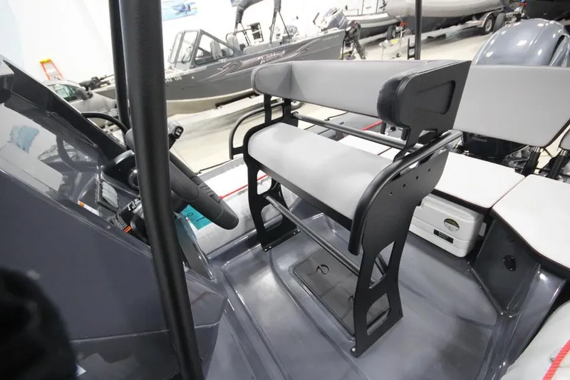 Slide: The Image of 2023 Zodiac Open 5.5 PVC boat with T-Top, docked in a marina. - 9