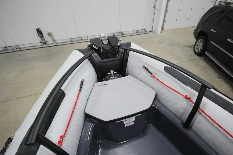 Slide: The Image of 2023 Zodiac Open 5.5 PVC boat with T-Top, 115hp engine, docked outdoors. - 16