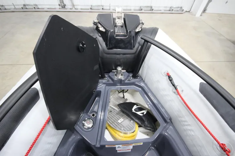 Slide: The Image of 2023 Zodiac Open 5.5 PVC boat with T-Top, docked, interior view. - 17