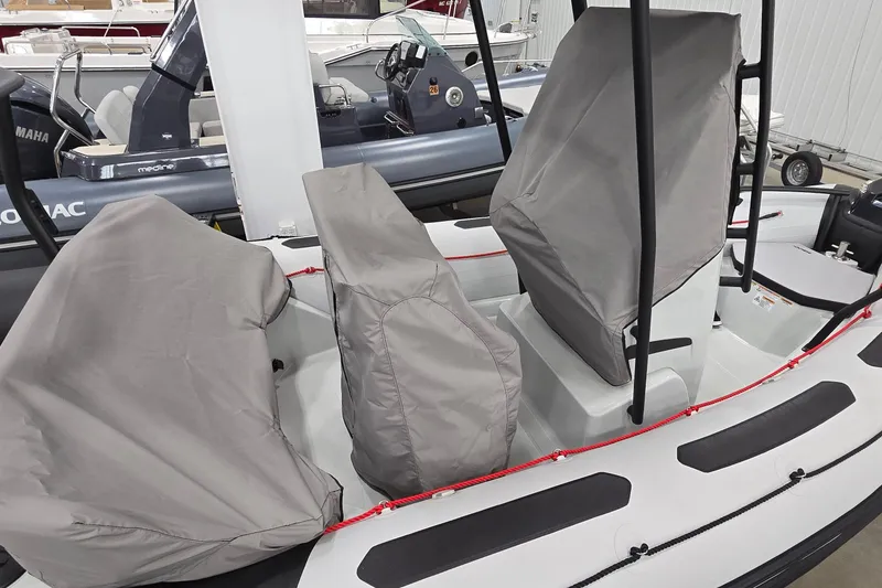 Slide: The Image of 2023 Zodiac Open 5.5 PVC boat with T-Top, displayed in a showroom. - 20