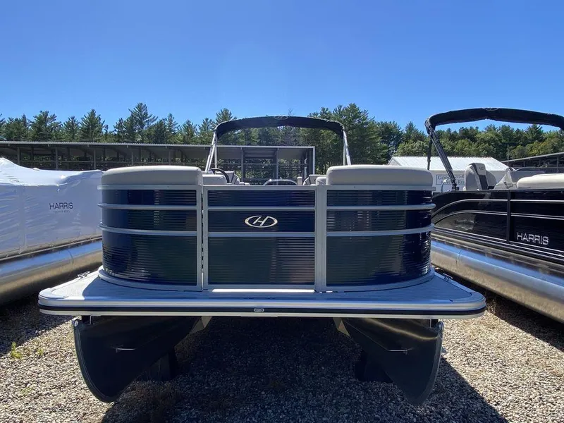 Slide: The Image of 2023 Harris Cruiser 250 CWDH pontoon boat in a sunny outdoor setting. - 4