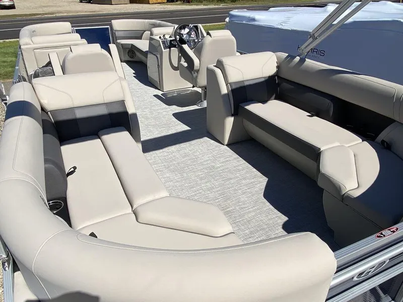 Slide: The Image of 2023 Harris Cruiser 250 CWDH pontoon boat with spacious seating and modern design. - 6