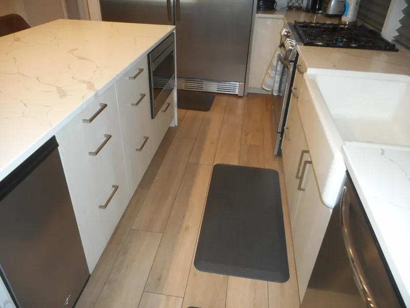 Slide: The Image of Modern kitchen with marble countertops, stainless steel appliances, and wooden flooring, Adonia Pace Share #8, 2021. - 16