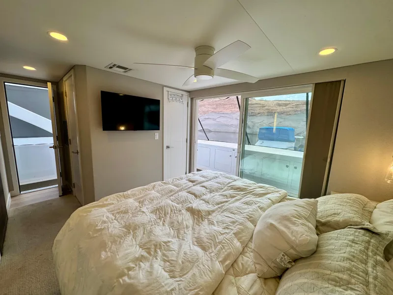 Slide: The Image of Modern bedroom interior in Adonia Pace Trip #7, 2021 model, featuring cozy bedding and a wall-mounted TV. - 19