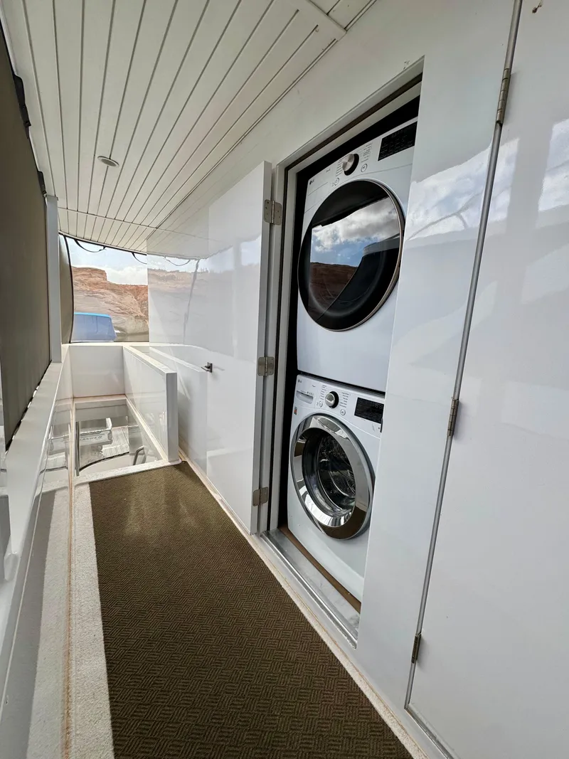 Slide: The Image of Stacked washer and dryer on Adonia Pace Trip #7, 2021 model, in a sleek white interior. - 23