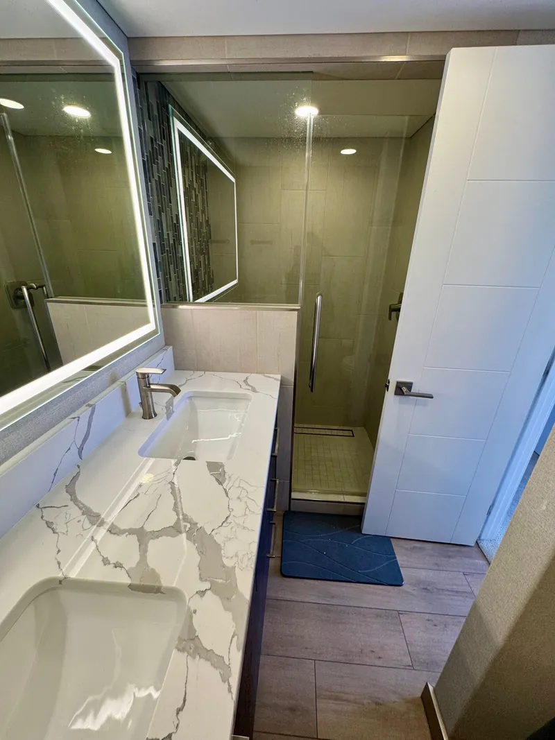 Slide: The Image of Modern bathroom in Adonia Pace Trip #7, 2021, featuring marble countertop and glass shower. - 27