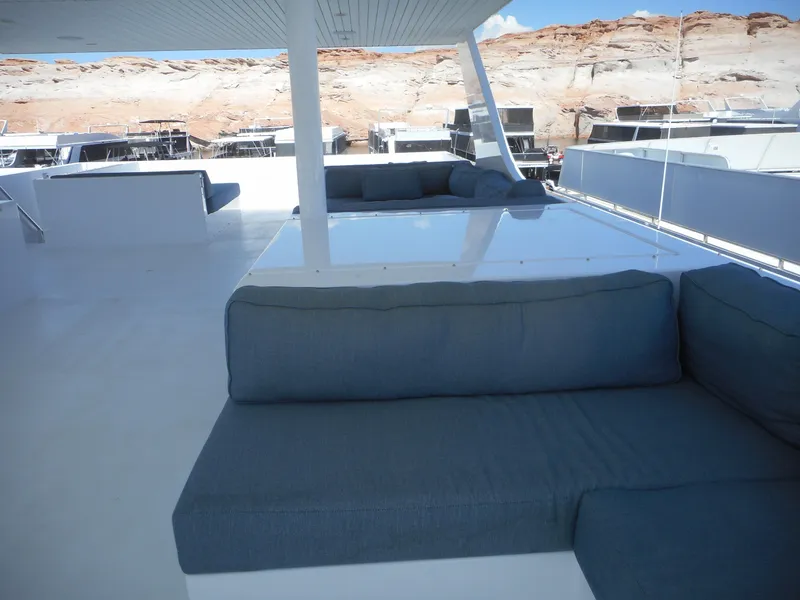 Slide: The Image of Upper deck of 2021 Adonia Pace Trip #7 houseboat with blue seating and scenic background. - 35