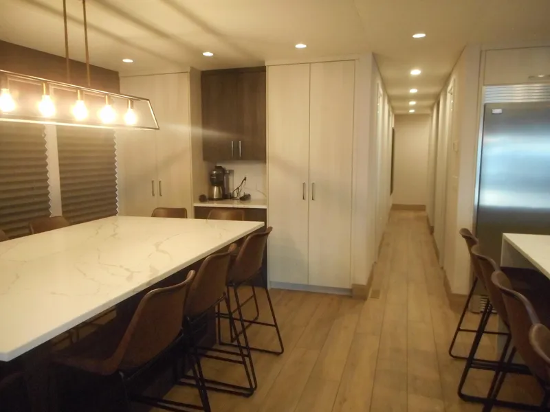 Slide: The Image of Modern kitchen with marble island, bar stools, and sleek cabinetry in Adonia Pace Share #8, 2021 model. - 4