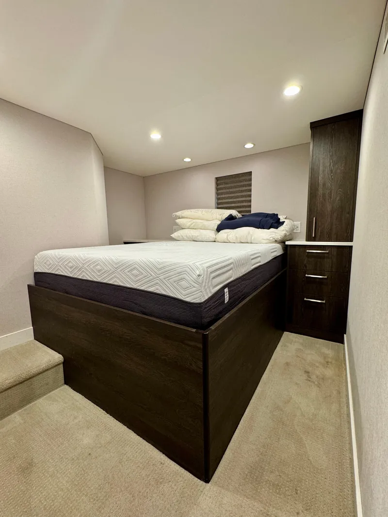 Slide: The Image of Compact bedroom in 2021 Adonia Pace Trip #7 RV with elevated bed and storage. - 7