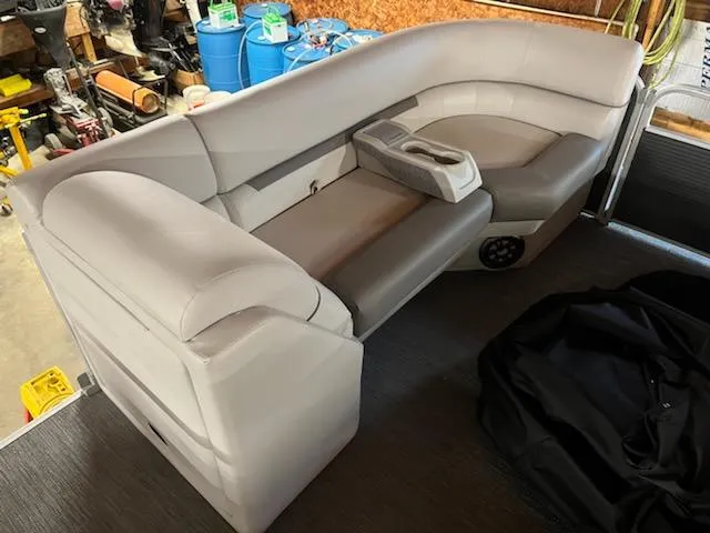Slide: The Image of 2023 Sweetwater 2286SBCX pontoon boat interior with plush seating and cup holders. - 5