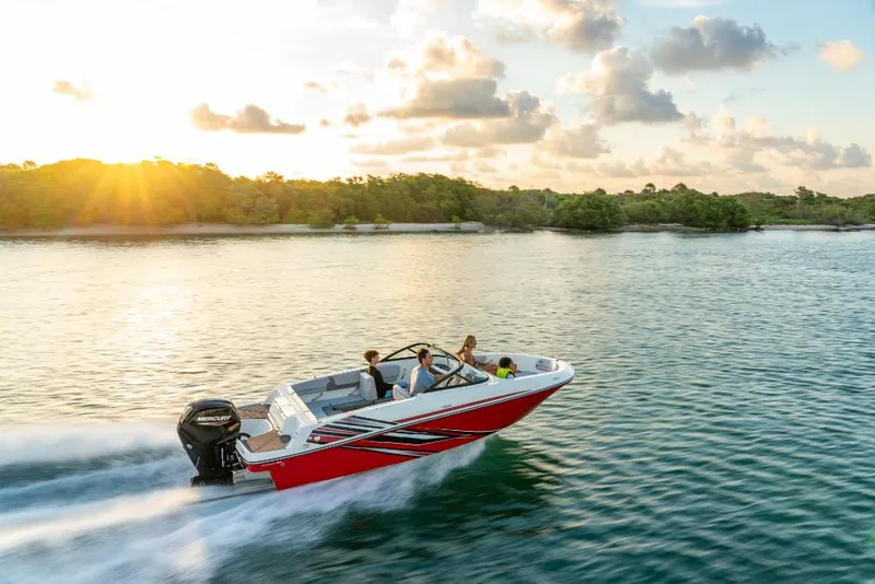 Slide: The Image of 2023 Bayliner M17 boat cruising on a lake at sunset. - 2