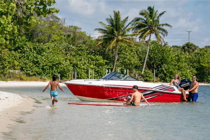 Slide: The Image of 2023 Bayliner M17 boat near tropical beach with people enjoying water activities. - 26