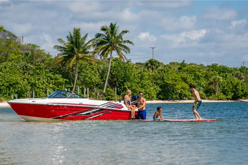 Slide: The Image of 2023 Bayliner M17 boat with people enjoying water activities near a tropical beach. - 28