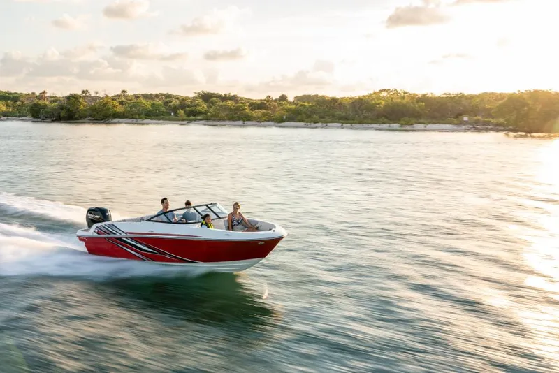Slide: The Image of 2023 Bayliner M17 boat cruising on a serene lake at sunset. - 7