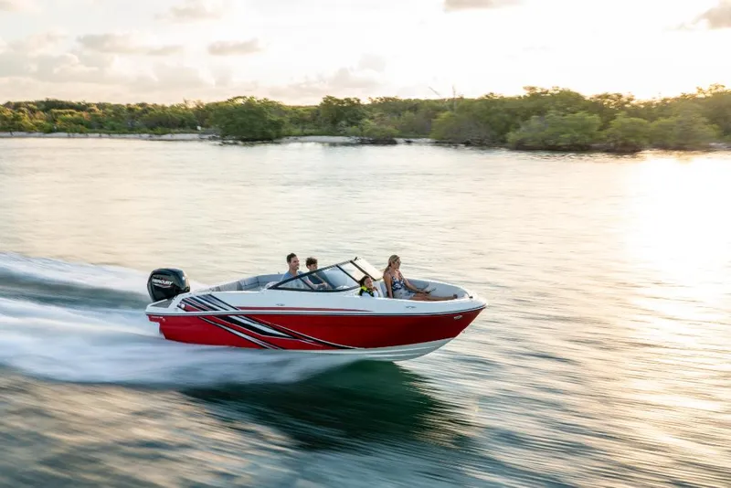 Slide: The Image of 2023 Bayliner M17 boat cruising on a serene lake at sunset. - 8