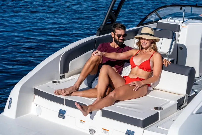 Slide: The Image of Couple relaxing on a 2023 Bayliner DX2000 boat in sunny weather. - 16