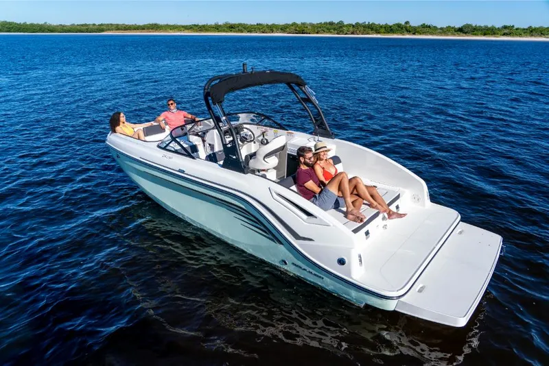 Slide: The Image of 2023 Bayliner DX2000 boat cruising on open water with passengers relaxing. - 21