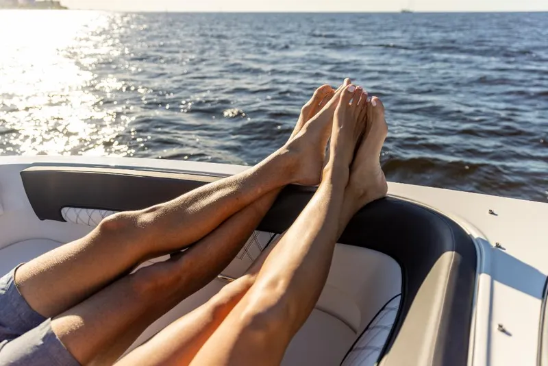Slide: The Image of Relaxing on a 2023 Bayliner DX2000 boat, feet up, enjoying the ocean view. - 38