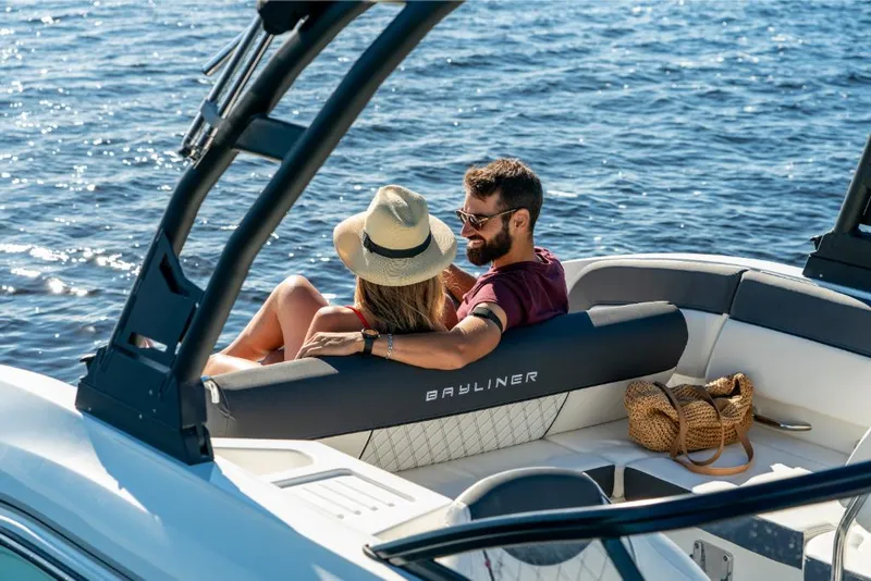 Slide: The Image of Couple relaxing on a 2023 Bayliner DX2050 boat on the water. - 17