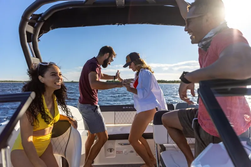 Slide: The Image of Friends enjoying a sunny day on a 2023 Bayliner DX2050 boat. - 36