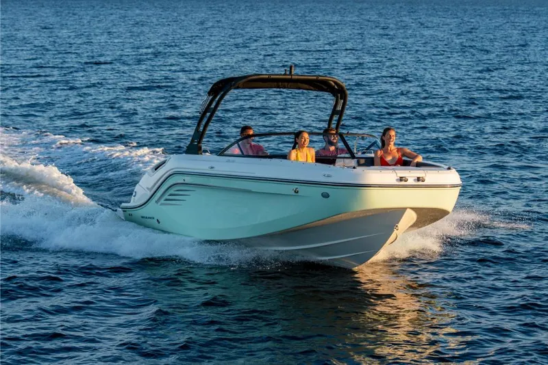 Slide: The Image of 2023 Bayliner DX2050 boat cruising on open water with passengers. - 4