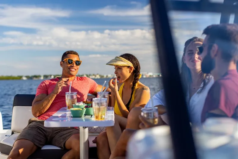 Slide: The Image of Friends enjoying drinks on a 2023 Bayliner DX2050 boat. - 47