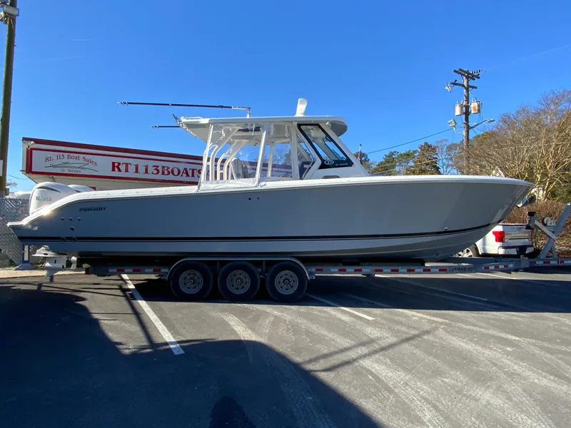 Slide: The Image of 2024 Pursuit S 328 Sport boat on a trailer in a parking lot. - 13