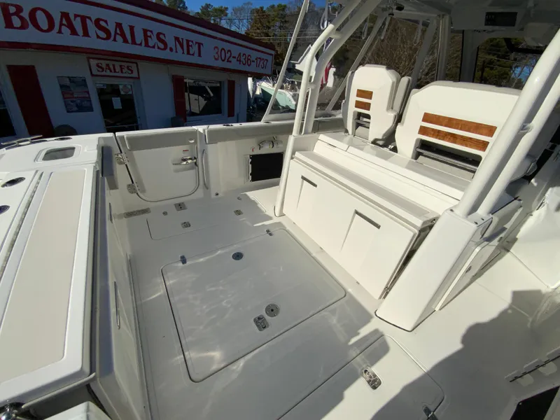 Slide: The Image of 2024 Pursuit S 328 Sport boat interior at a dealership. - 20