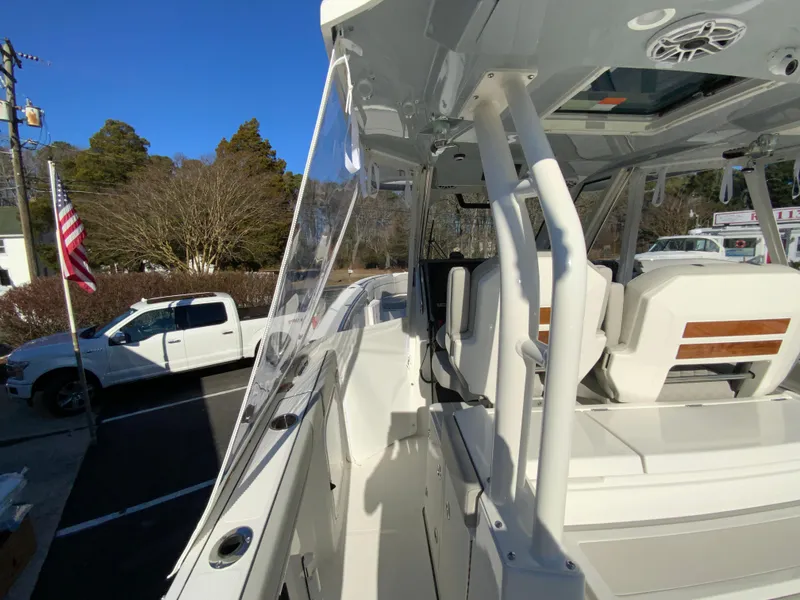 Slide: The Image of 2024 Pursuit S 328 Sport boat, side view, white exterior, parked outdoors. - 23