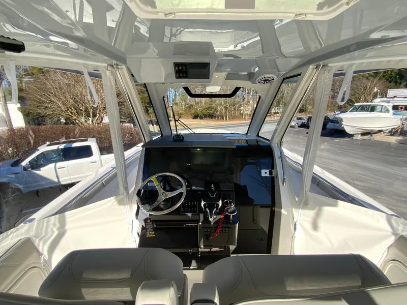 Slide: The Image of 2024 Pursuit S 328 Sport boat cockpit with modern controls and steering wheel. - 24