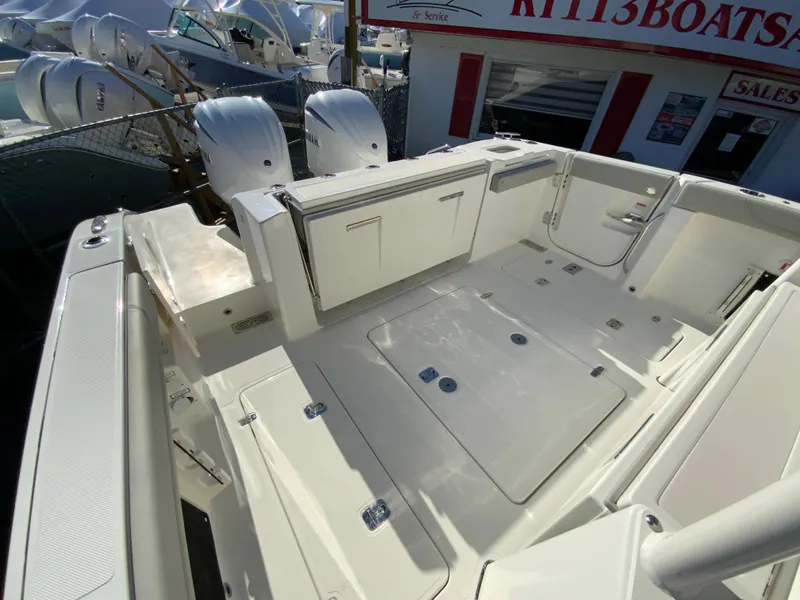 Slide: The Image of 2024 Pursuit S 328 Sport boat deck with twin outboard engines. - 25