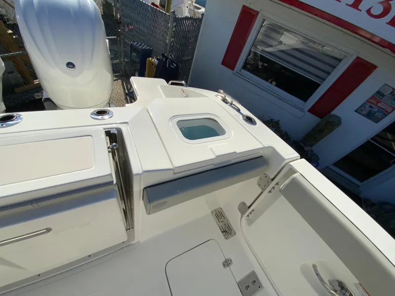 Slide: The Image of 2024 Pursuit S 328 Sport boat deck with storage compartments and seating. - 28