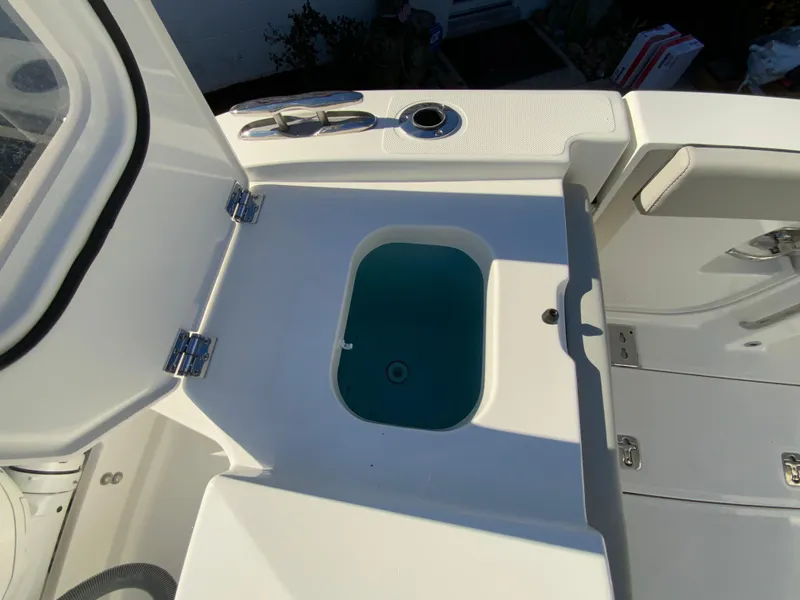 Slide: The Image of 2024 Pursuit S 328 Sport boat livewell and storage compartment. - 29