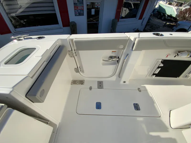 Slide: The Image of 2024 Pursuit S 328 Sport boat deck with storage compartments and seating. - 30