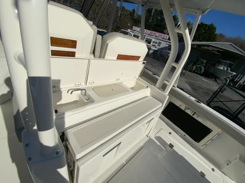 Slide: The Image of 2024 Pursuit S 328 Sport boat interior with seating and storage compartments. - 33