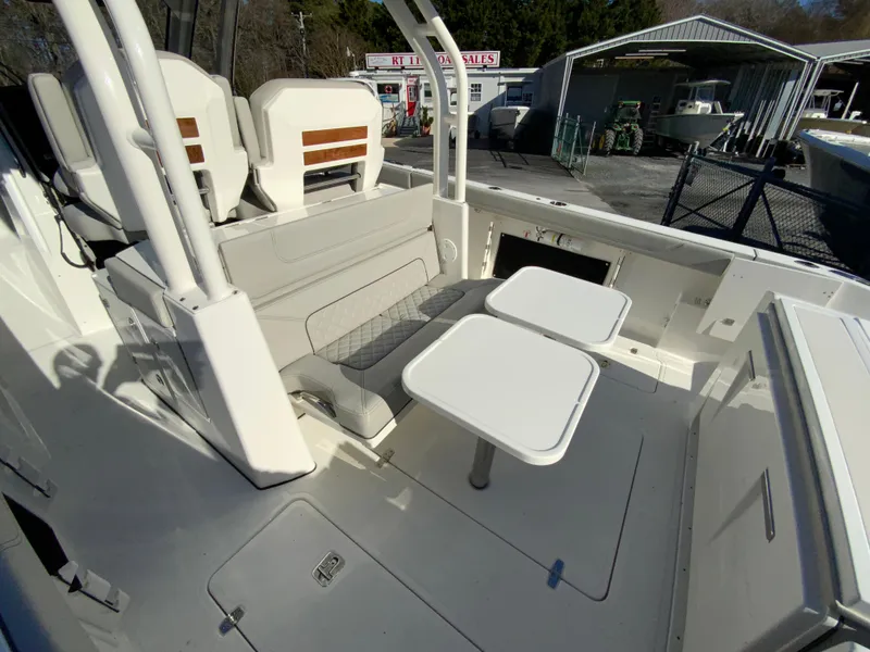 Slide: The Image of 2024 Pursuit S 328 Sport boat interior with seating and tables. - 36