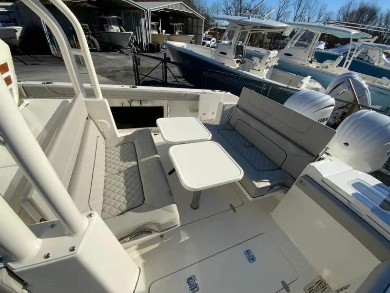 Slide: The Image of 2024 Pursuit S 328 Sport boat interior with seating and tables. - 37