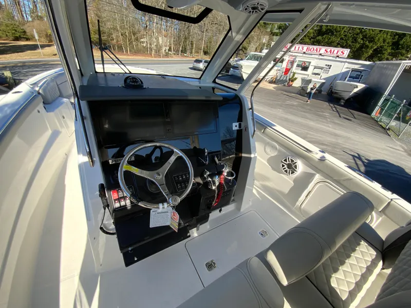 Slide: The Image of 2024 Pursuit S 328 Sport boat interior with steering wheel and dashboard. - 39
