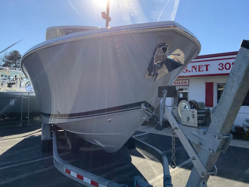 Slide: The Image of 2024 Pursuit S 328 Sport boat on a trailer in a dealership lot. - 4