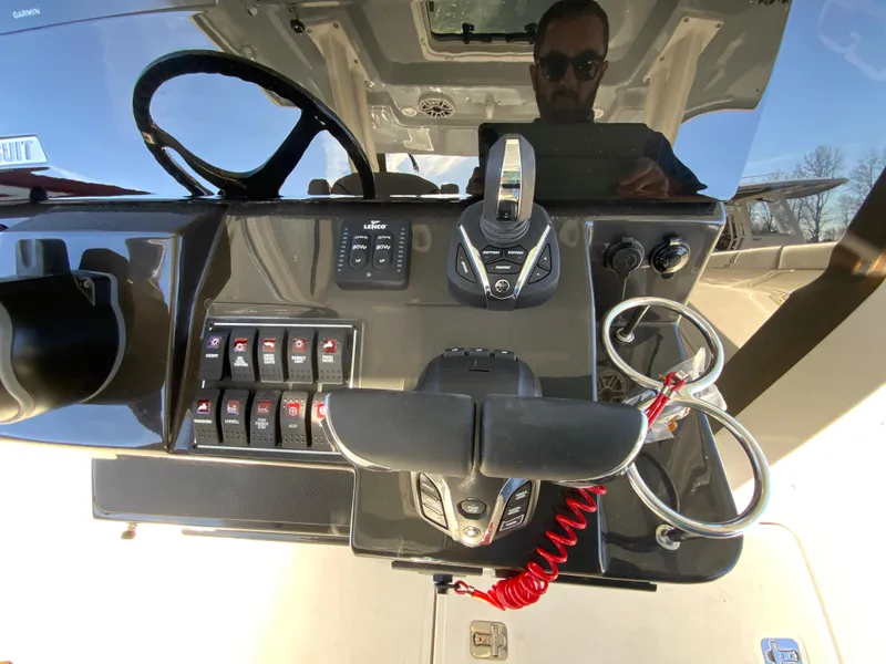 Slide: The Image of Control panel of 2024 Pursuit S 328 Sport boat with steering wheel and switches. - 40