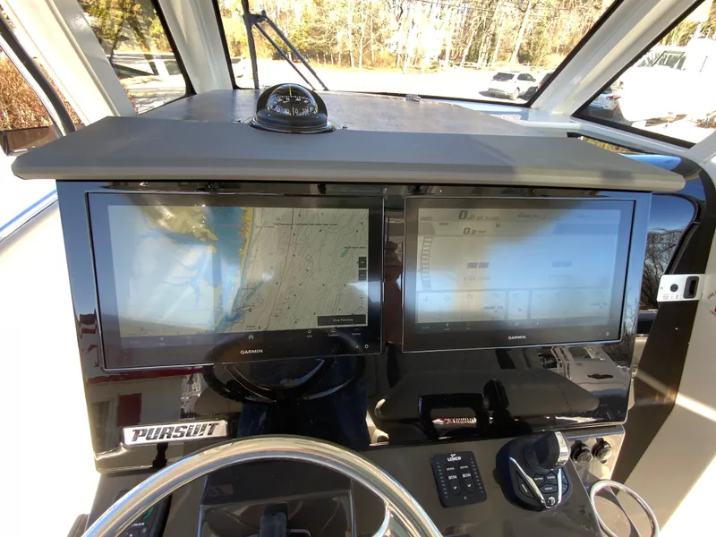 Slide: The Image of 2024 Pursuit S 328 Sport boat dashboard with dual navigation screens. - 42