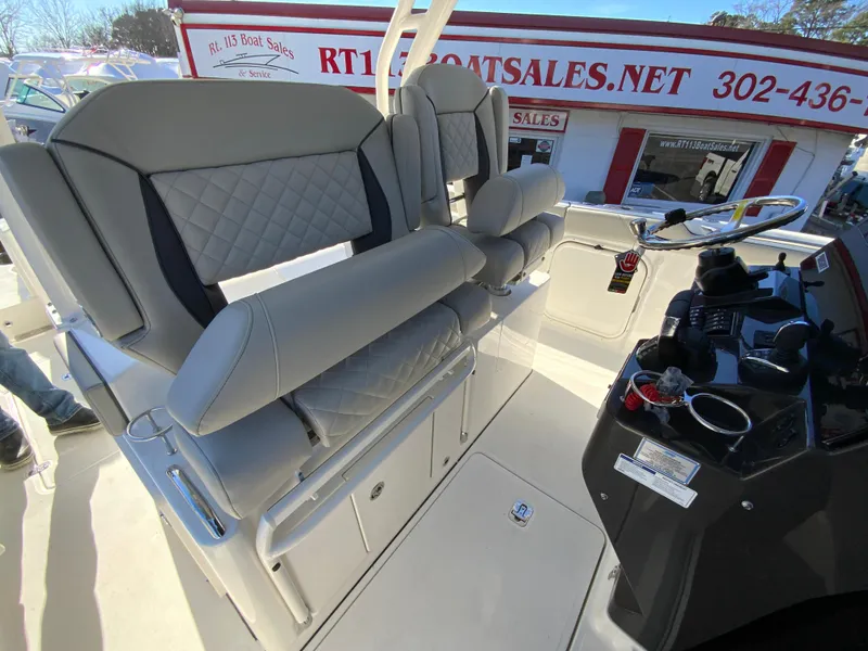 Slide: The Image of 2024 Pursuit S 328 Sport boat interior with dual captain's chairs and control console. - 45